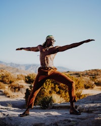 a man practicing yoga in the desert