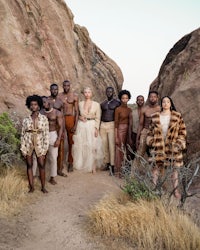 a group of people posing in front of rocks