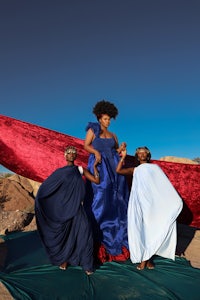 a woman in a blue dress and a girl in a blue dress posing for a photo